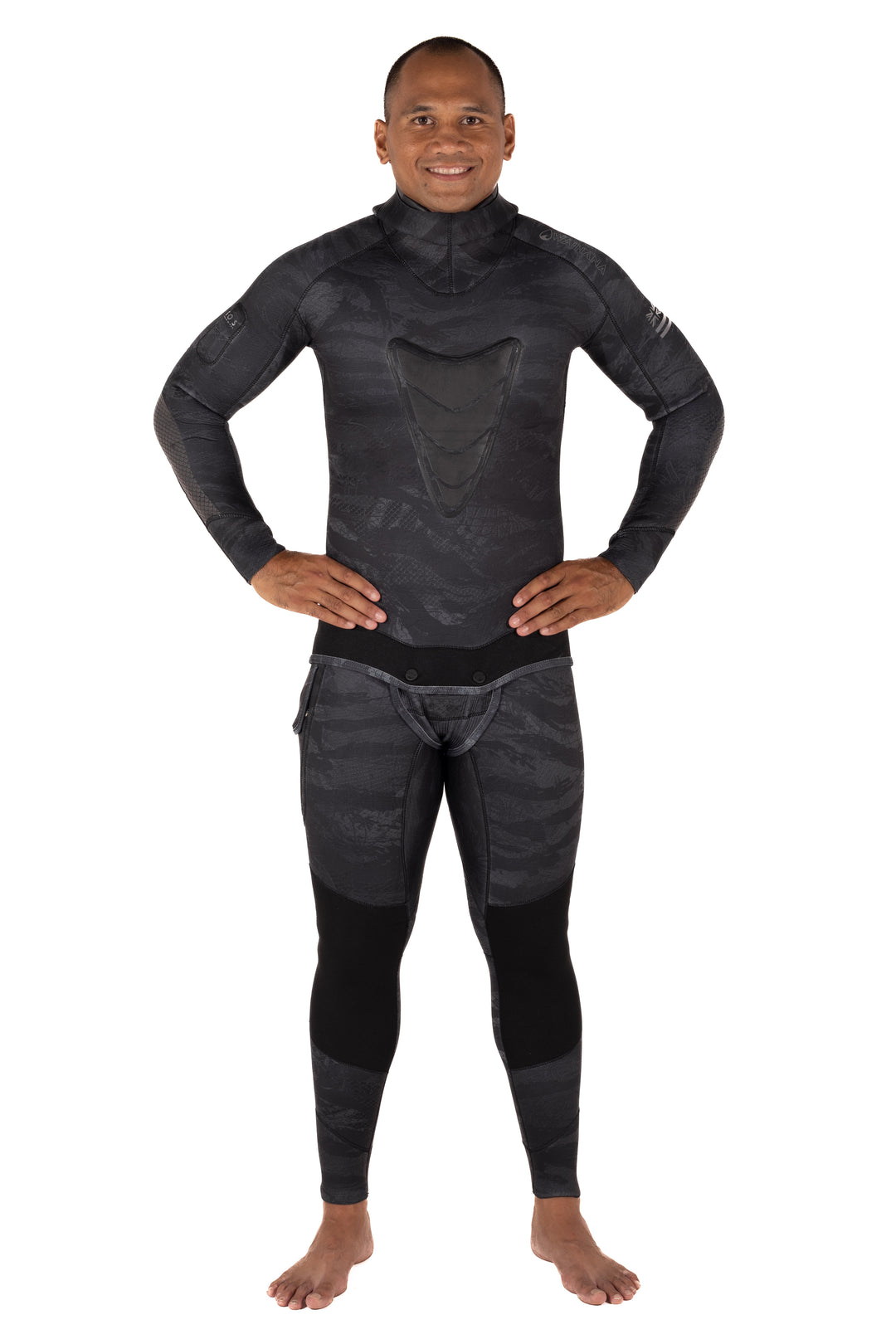 Male model wearing the Waihana Men's Tropicam Black 3.5mm spearfishing wetsuit with dark camo print, chest loading pad, and matching pants, shown front-facing against a white background.